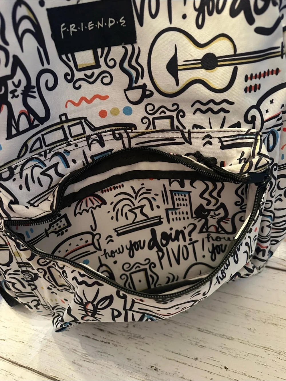 FRIENDS White Backpack with Black Accents and Multicolor Doodles